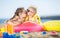 Gorgeous brother and sister sunbathing on a sandy beach