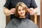 Gorgeous brunette short hair woman and her male hairdresser looking and checking out hairstyle. Beautiful hairstyle of a