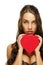 Gorgeous brunette woman holding red heart