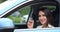 Gorgeous businesswoman driver shows key to new car smiling