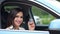 Gorgeous businesswoman driver shows key to new car smiling