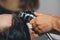 Gorgeous cheerful elderly woman enjoys a head massage while washing her hair by a professional hairdresser. Beauty care, hairstyle