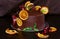 Gorgeous chocolate cake decorated with slices of baked orange and fresh pomegranate with a sprig of mint on a dark brown backgroun