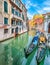 Gorgeous cityscape of Venice with narrow canals, boats and gondolas and bridges with traditional buildings