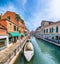 Gorgeous cityscape of Venice with narrow canals, boats and gondolas and bridges with traditional buildings