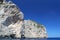 Gorgeous cliff in Mediterranean sea with Lighthouse on the top. Turquoise sea water and blue sky. Spain. Palma de Majorka.