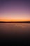 A gorgeous color and contrast over the lake at sunset. Vertical frame.