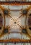 Gorgeous crystal round chandelier in an ornate old hall