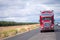 Gorgeous custom tuned red semi truck rig with reefer trailer