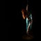 Gorgeous dancer in night club. woman in a long turquoise dress with a slit on a dark background. free space for
