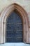 Gorgeous detail in arched stone and brass doorway