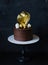 Gorgeous extra chocolate cake with gilded glaze and twist
