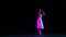 Gorgeous female dancer in ballet dress dancing solo part on dark stage in neon light. Concept of art, beauty, theater