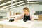 Gorgeous female worker staining a table with wood oil stain