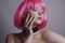 Gorgeous french manicure on a bright girl with pink hair. Fashion photo of a model with beautiful hands, and long nails.