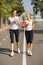 Gorgeous girls running on the blurred background. Sporty youth. Morning jogging concept.