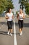 Gorgeous girls running on the blurred background. Sporty youth. Morning jogging concept.