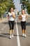 Gorgeous girls running on the blurred background. Sporty youth. Morning jogging concept.