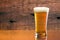 Gorgeous glass of delicious beer with barn wood background