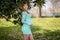 A Gorgeous Glowing Pregnant Woman Poses In An Outdoor Environment