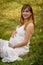 A Gorgeous Glowing Pregnant Woman Poses In An Outdoor Environment