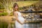 A Gorgeous Glowing Pregnant Woman Poses In An Outdoor Environment