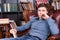 Gorgeous Guy Sitting on the Chair Holding a Book