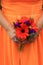 Gorgeous image of bridesmaid dress, with young lady in orange, holding bouquet