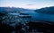 Gorgeous image of Queenstown with snow capped mountains in the background taken during an orange sunset from Skyline Queenstown,