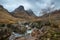 Gorgeous landscape image of vibrant River Coe flowing beneath snowcapped mountains in Scottish Highlands