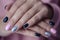 Gorgeous manicure, pastel tender pink color nail polish, closeup photo.