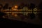 Gorgeous night landscape over the lake. Light reflected in the water.