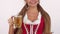 Gorgeous Oktoberfest woman in dirndl dress holding beer showing thumbs up