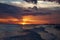 A gorgeous orange sky at sunset in Ft.Myers Beach, Florida as the waves roll onto the shore.