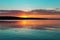 Gorgeous orange teal sunset on huge calm lake