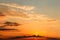 Gorgeous panorama scenic of the strong sunset with clouds on the orange sky