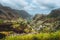 Gorgeous panorama view of a fertile Paul valley. Agriculture terraces in vertical valley sides, rugged peaks and motion
