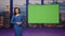 Gorgeous presenter beginning broadcast breaking news near green screen tv studio