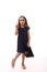 Gorgeous pretty 4 years old little Caucasian European girl wearing evening attire, hold a shopping black packet and point on a