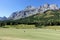 Gorgeous putting green surrounded by forest and big mountains in the background, on a beautiful sunny day in Kananaskis, Alberta