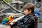 Gorgeous school kid boy feeding parrots in zoological garden. Child playing and feed trusting friendly birds in zoo and