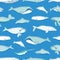 Gorgeous seamless pattern with various aquatic marine mammals hand drawn on blue background - whales, narwhal, dolphin