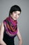 Gorgeous short hair brunette beauty wearing colorful shawl around neck looking at camera