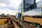 A gorgeous shot of the autumn landscape in the city with glass buildings with color murals and a green construction crane