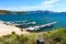 Gorgeous shot of boats in the docks and deep blue water, blue skies and lush green mountains at Diamond Valley Lake