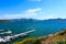 Gorgeous shot of boats in the docks and deep blue water, blue skies and lush green mountains at Diamond Valley Lake