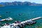 Gorgeous shot of boats in the docks and deep blue water, blue skies and lush green mountains at Diamond Valley Lake