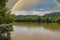 A gorgeous shot of the still brown waters of the Chattahoochee river surrounded by lush green trees reflecting off the river water