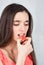 Gorgeous slim girl seductively eating fruit candy