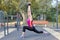 Gorgeous slim young woman practices yoga at outdoor sportsground. Hero asana. Calmness and relax, stretching. Real woman morning t